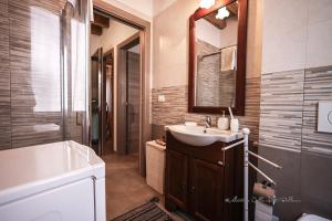 a bathroom with a sink and a mirror at Sole e Vento in Chioggia