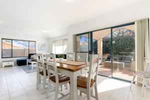 a kitchen and dining room with a table and chairs at Avalon Beach Escape ~ Family Favourite with Wifi in Mandurah