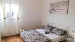 Posteľ alebo postele v izbe v ubytovaní Apartment Diocletian