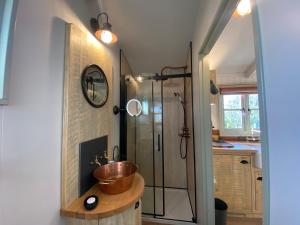 a bathroom with a sink and a shower at Holly Lodge Boutique B&B in Thursford