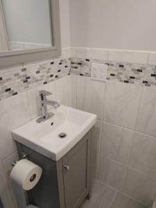 a bathroom with a sink and a toilet paper roll at Little peace of heaven in Corning +10 photos