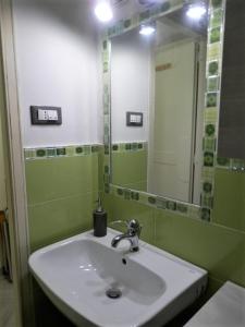 a bathroom with a sink and a mirror at Residence _Capo Gallo in Palermo +7 photos