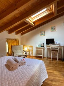 a bedroom with a bed and a desk and a television at B&B Golf Club Le Vigne in Villafranca di Verona