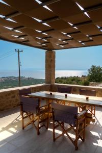 a table and chairs on a patio with a view at Kika Residences in Agios Nikolaos