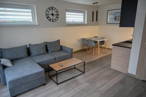 a living room with a couch and a table at NORD HOUSE Apartamenty in Władysławowo