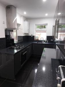 a black and white kitchen with a stove and a sink at Riverside in York