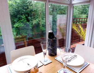 a table with glasses and a bottle of wine on it at Riverside in York