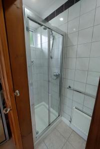 a shower with a glass door in a bathroom at Riverside in York