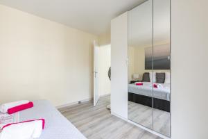 a bedroom with a bed and a mirror at Sweet Family Vacations - Fairytale Factory in Chessy
