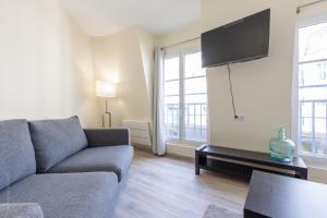 a living room with a couch and a tv at Sweet Family Vacations - Fairytale Factory in Chessy