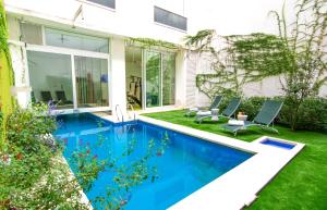 a swimming pool in the yard of a house at Boutique Suites Palermo in Buenos Aires