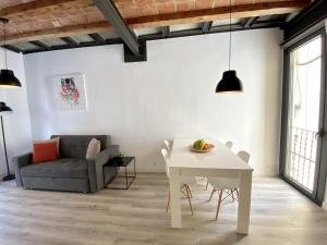 a living room with a white table and a couch at Sants Montjuic Olympic View in Barcelona