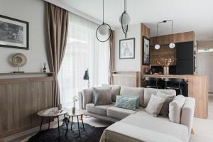 a living room with a couch and a table at Downtown Penthouse Budapest in Budapest