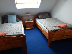 Habitación pequeña con 2 camas individuales y ventana en Deichgraf, en Greetsiel