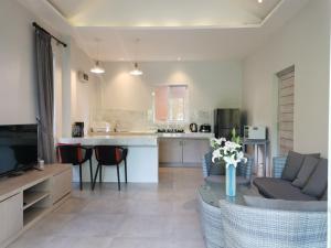 a kitchen and living room with a couch and a table at Phalarn Inn Resort in Mae Nam