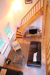 a living room with a couch and a staircase at Blick aufn See in Sternberg