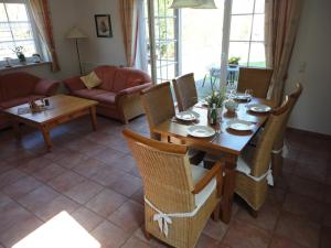 a living room with a wooden table and chairs at Friesenstern in Norden