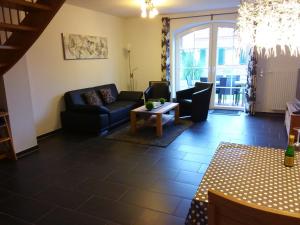 a living room with a couch and a table at Grachtenperle in Greetsiel