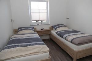 Postel nebo postele na pokoji v ubytování Friesenzauber