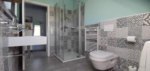 a bathroom with a toilet and a shower and a sink at Dat Hygge Huus in Greetsiel +23 photos