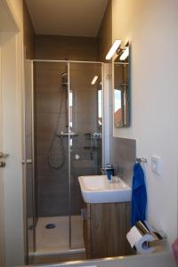 a bathroom with a shower and a sink and a shower at Wellenbrecher in Greetsiel