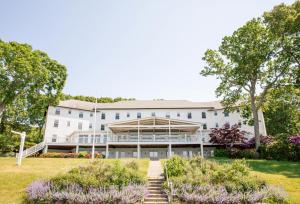a large white building with a garden in front of it at The Pridwin Hotel in Shelter Island