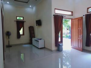 an empty living room with a door and a table at Griya PAS Pangandaran in Pangandaran