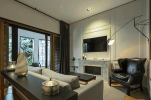 a living room with a couch and a fireplace at Brick Hotel Mexico City - Small Luxury Hotels of the World in Mexico City