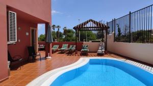 a patio with a swimming pool and a house at Dream Villa in Adeje