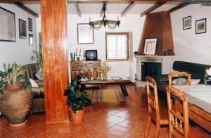 a living room with a table and a fireplace at Quinta do Vale Sanguinho in Seia