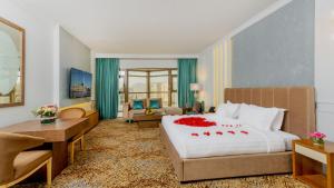 a bedroom with a large bed and a living room at Mias Al Madina Hotel in Al Madinah +49 photos