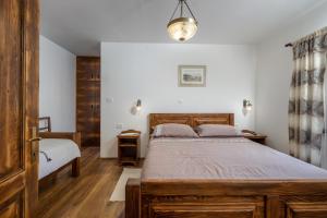 a bedroom with a large bed and a window at Villa Simici quiet peaceful place with pool perfect to enjoy the nature in Mošćenička Draga