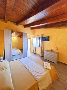 a bedroom with a large bed in a room at Agriturismo Bella Vista - Da Carmelo in Santa Teresa di Riva