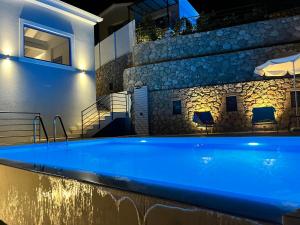 a swimming pool in a villa at night at Katerina's Village Agios Nikitas in Agios Nikitas