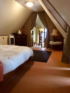 a bedroom with a large bed and a window at La Petite Maison, Vignols in Vignols