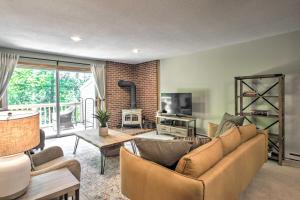 a living room with a couch and a tv at North Conway Condo in the White Mountains! in North Conway