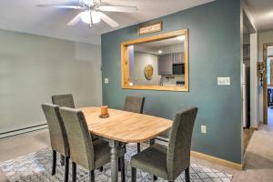 a dining room with a table and chairs and a mirror at North Conway Condo in the White Mountains! in North Conway