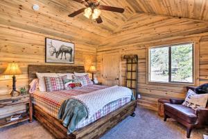 a bedroom with a bed and a ceiling fan at Jefferson Cabin with Fire Pit Near Hiking Trails! in Bordenville