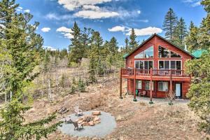 a log home in the woods with a fire pit at Jefferson Cabin with Fire Pit Near Hiking Trails! in Bordenville
