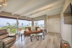 a living room with a couch and a table at Stunning Palos Verdes Escape Pool, Fire Pit! in Rancho Palos Verdes