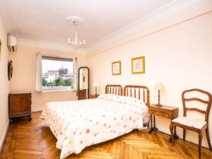 a bedroom with a bed and a window at Miramar. Basquenjoy in Hondarribia