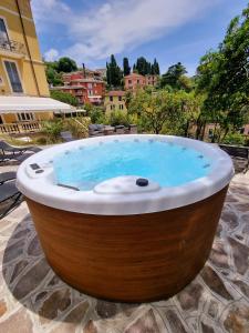 a large wooden bath tub with blue water in it at Hotel Canali, Portofino Coast in Rapallo