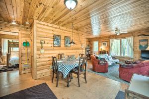 a dining room and living room with a table and chairs at Waterfront Escape w/ Fire Pit in Crosslake! in Cross Lake +27 photos