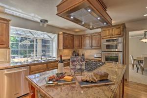 a kitchen with a counter with bread and wine bottles at Redding Getaway with Hot Tub and Outdoor Kitchen! in Redding