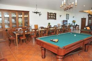 a room with a pool table and a dining room at Quinta do Vale Sanguinho in Seia