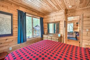 a bedroom with a large bed in a log cabin at Waterfront Escape w/ Fire Pit in Crosslake! in Cross Lake