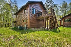 a wooden house with a deck on the side of it at Waterfront Escape w/ Fire Pit in Crosslake! in Cross Lake
