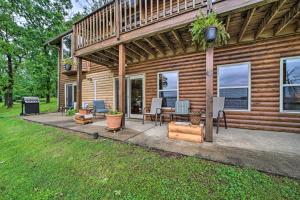 a house with a patio with a table and chairs at Boat Dock and Fire Pit Sunset Cove Lakefront Gem in Jay