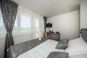 a bedroom with a large bed and a window at Sunrise View Balcony in Split +23 photos