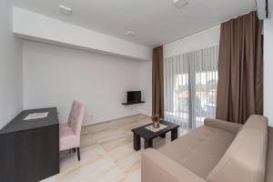 a living room with a couch and a table at N Hotel in Sutomore